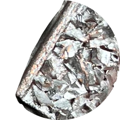Close-up of a solid steel cleat coated with tungsten carbide grit